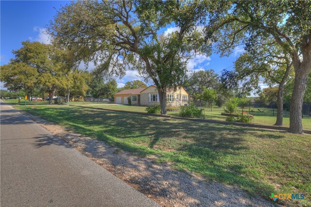 ranch-style home with a front lawn