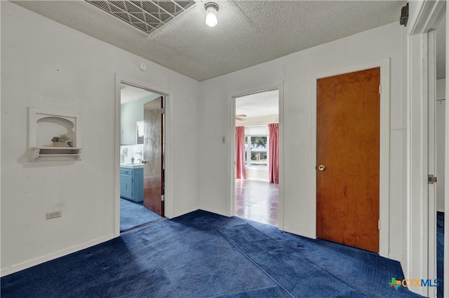 800 N Bishop St, San Marcos, TX 78666 - empty room with carpet floors and a textured ceiling