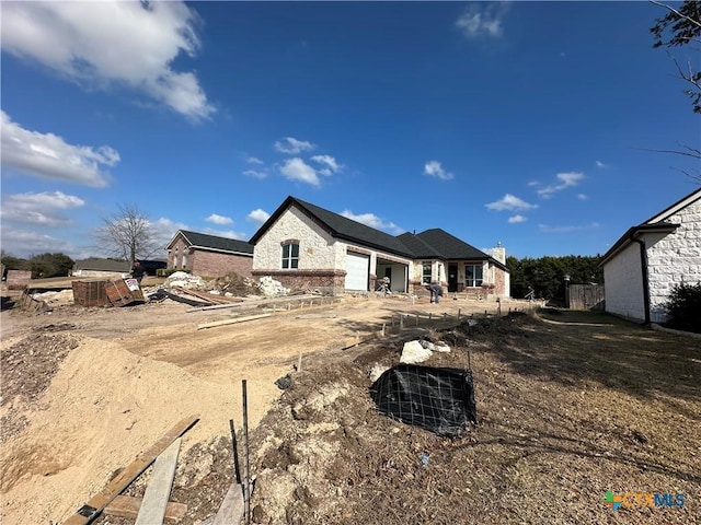 back of property with a garage