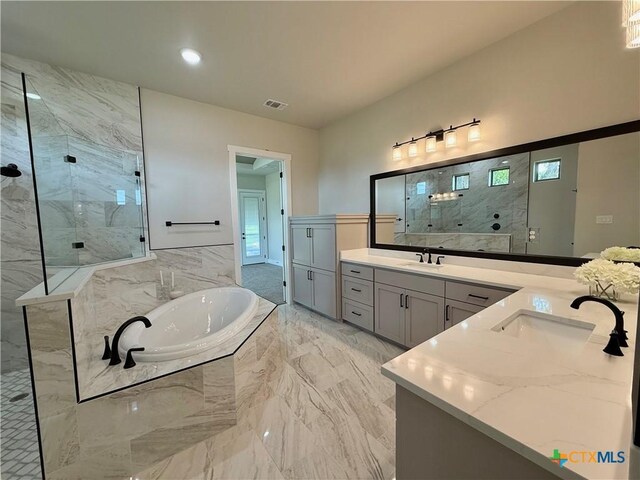 5101 Sunflower Ln, Temple, TX 76502 - bathroom with a garden tub, double vanity, marble tiled flooring, a marble finish shower, and recessed lighting
