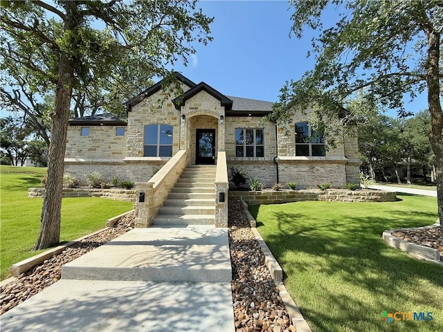 5101 Sunflower Ln, Temple, TX 76502 - french country inspired facade with a front yard, stone siding, and brick siding