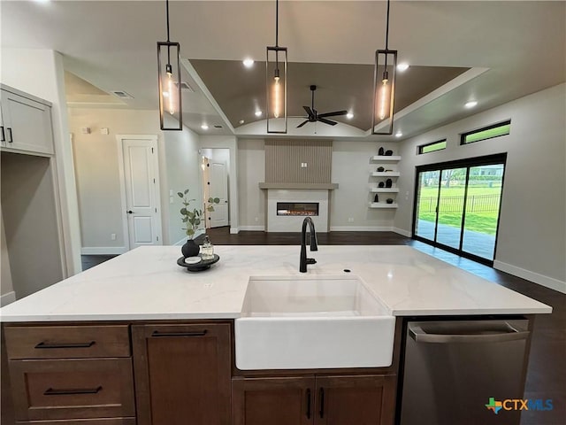 5101 Sunflower Ln, Temple, TX 76502 - kitchen featuring stainless steel dishwasher, ceiling fan, light stone countertops, a glass covered fireplace, and recessed lighting