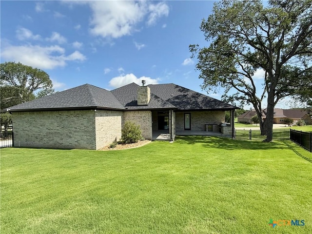 5101 Sunflower Ln, Temple, TX 76502 - rear view of house featuring a fenced backyard, brick siding, and a shingled roof