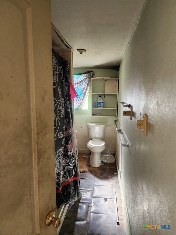 bathroom featuring tile patterned floors and toilet