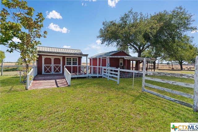 view of yard featuring a rural view and an outdoor structure