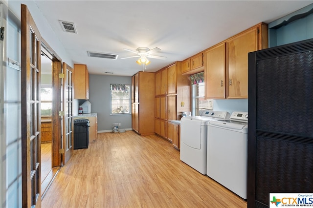 laundry room with light wood-type flooring, washer and dryer, and ceiling fan