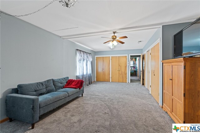 living room with carpet flooring and ceiling fan