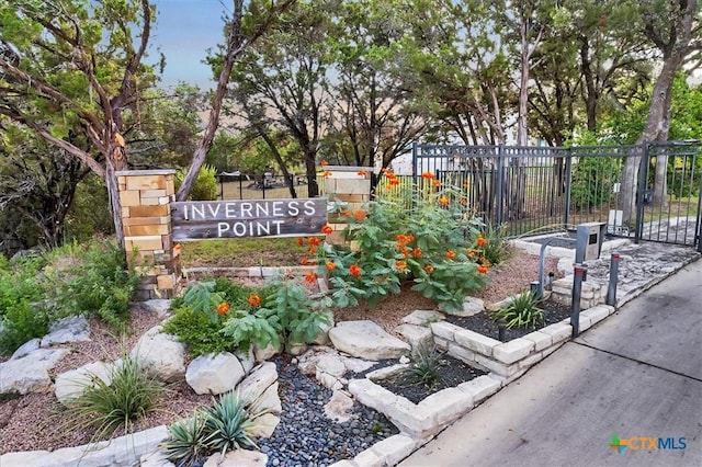 community / neighborhood sign with fence