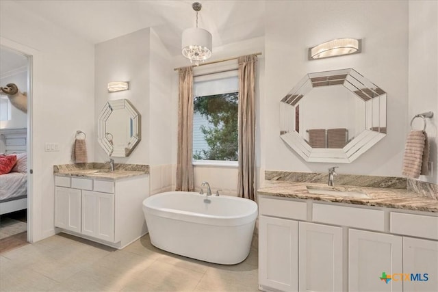 full bath featuring a soaking tub, two vanities, a sink, ensuite bath, and tile patterned flooring