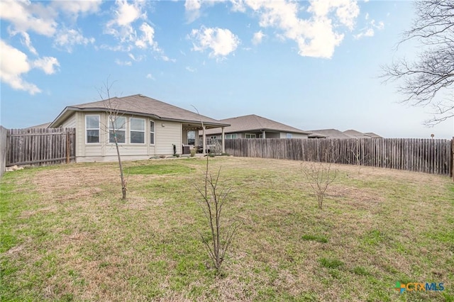 view of yard with a patio area and a fenced backyard