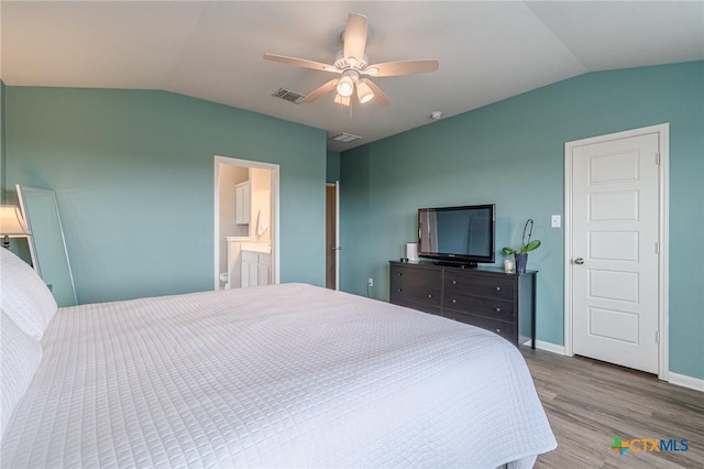 bedroom featuring visible vents, a ceiling fan, wood finished floors, baseboards, and vaulted ceiling