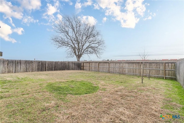 view of yard with a fenced backyard