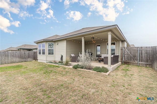 rear view of property featuring a patio, a fenced backyard, a lawn, and an outdoor hangout area