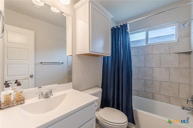 full bath with vanity, toilet, and shower / tub combo