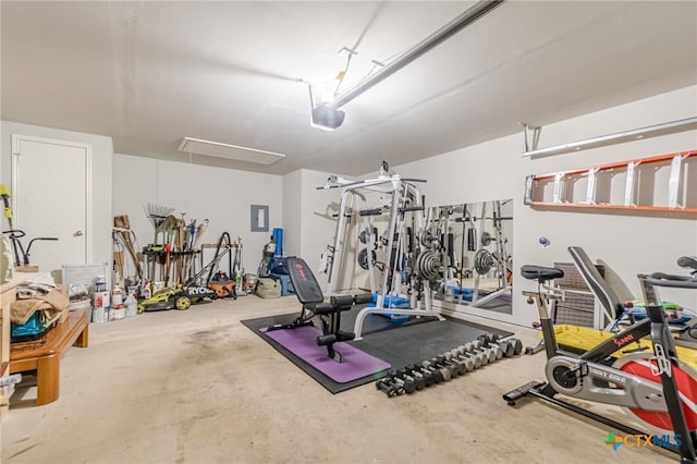 exercise room with attic access and a garage