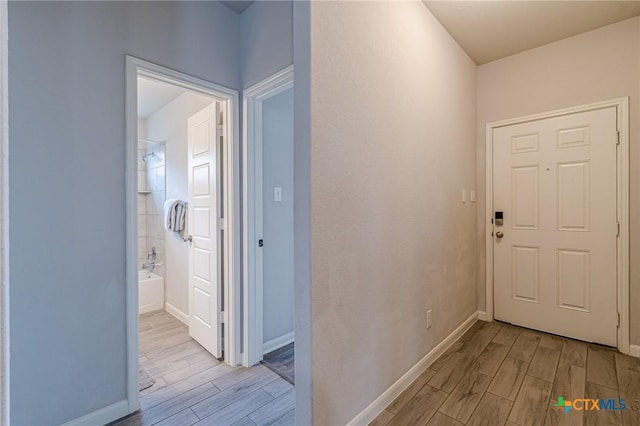 interior space with baseboards and wood tiled floor