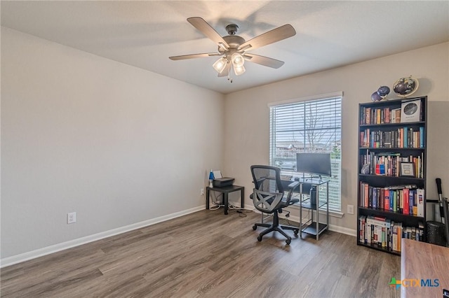 office area with baseboards, wood finished floors, and a ceiling fan