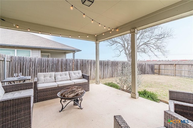 view of patio / terrace with an outdoor living space with a fire pit and a fenced backyard