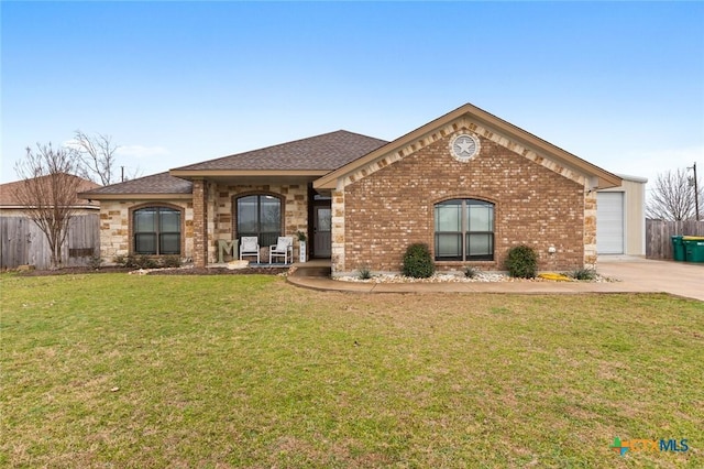 single story home with driveway, brick siding, a front yard, and fence