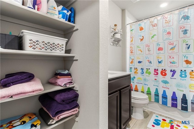 full bathroom with vanity, toilet, shower / bath combination with curtain, and wood-type flooring