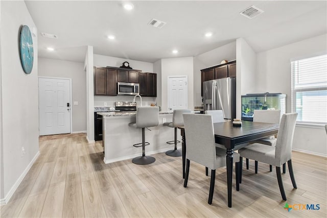 dining space featuring light wood-type flooring