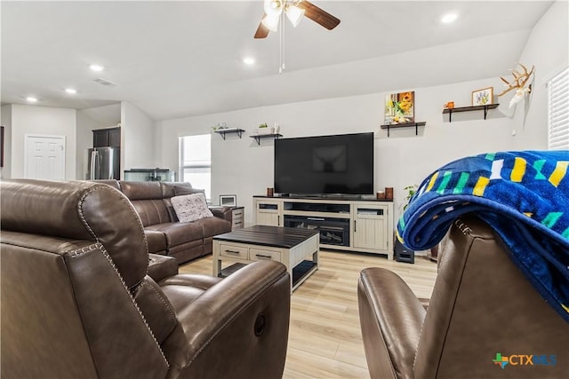 living room with ceiling fan and light hardwood / wood-style floors