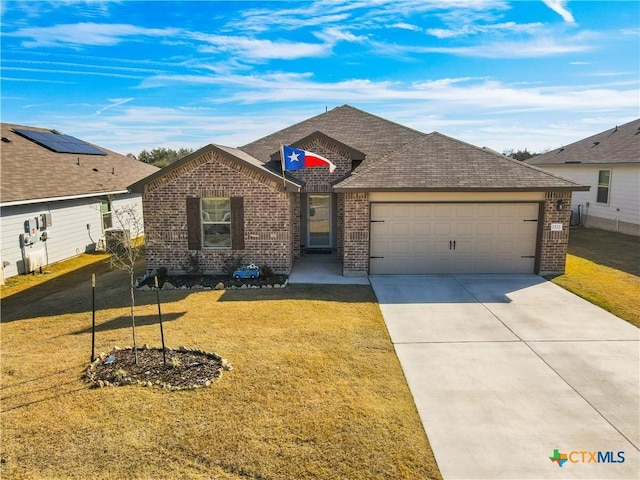 ranch-style house featuring a front yard and a garage