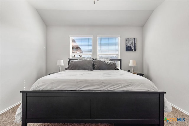 carpeted bedroom with vaulted ceiling