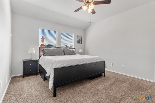 carpeted bedroom with ceiling fan and vaulted ceiling