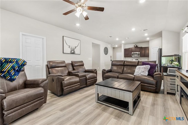 living room with light wood-type flooring and ceiling fan