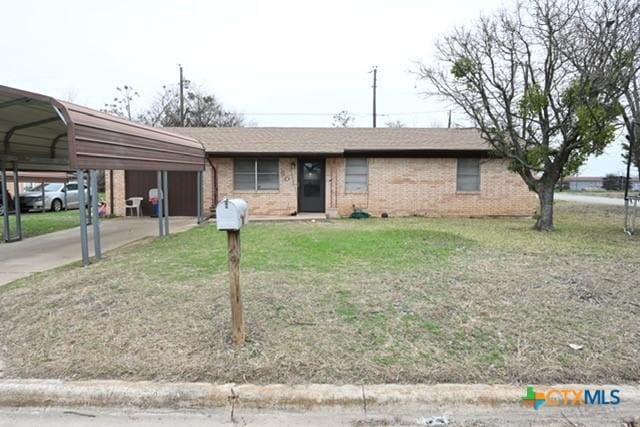 ranch-style house with a carport and a front lawn