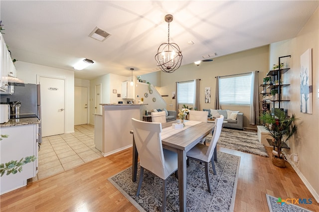 dining room featuring light hardwood / wood-style floors and an inviting chandelier