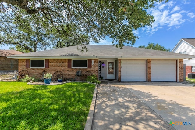 5 Windward Dr, Belton, TX 76513 - single story home featuring an attached garage, concrete driveway, brick siding, a front yard, and central air condition unit