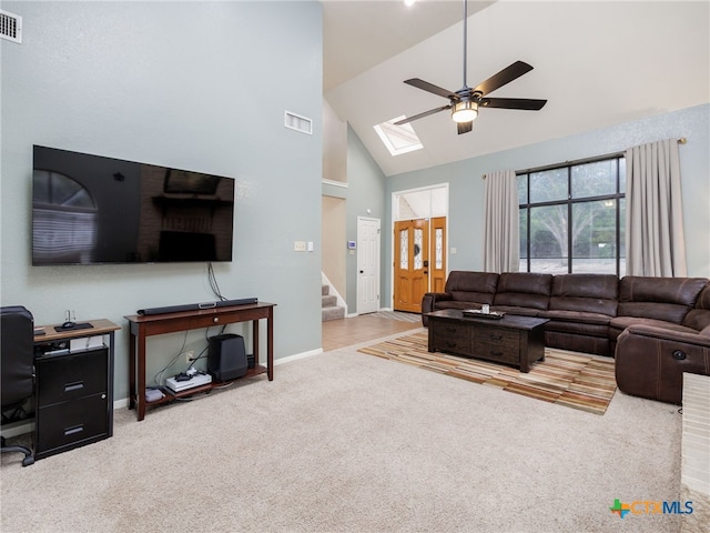 living room with visible vents, a ceiling fan, stairway, carpet flooring, and high vaulted ceiling