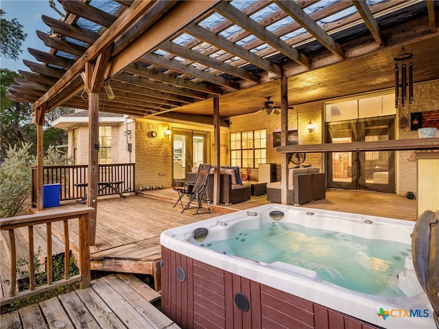 wooden terrace featuring a hot tub, an outdoor hangout area, and a pergola