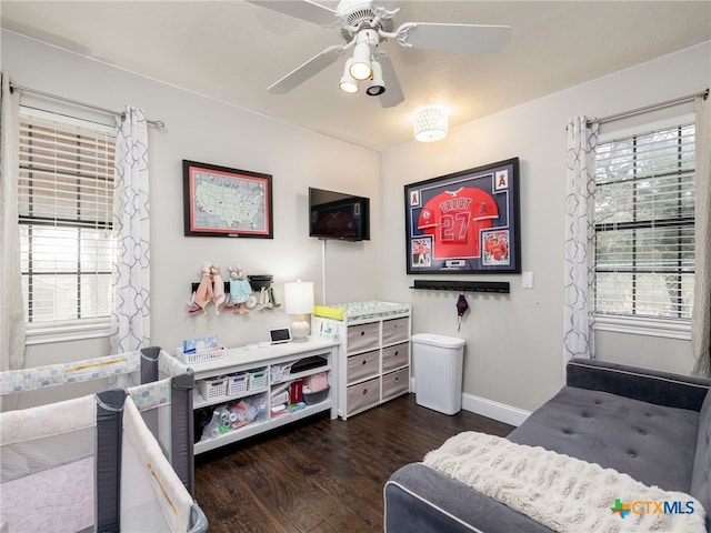 bedroom featuring dark wood-style floors, baseboards, and a ceiling fan