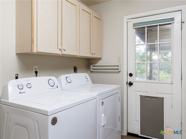 washroom featuring cabinet space and separate washer and dryer