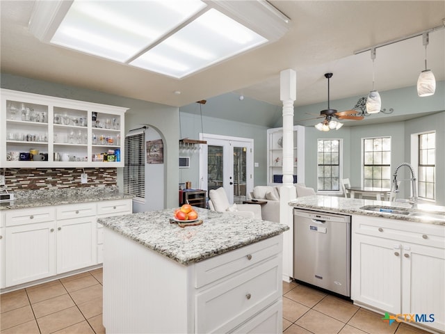 kitchen featuring french doors, open shelves, a kitchen island, a sink, and dishwasher