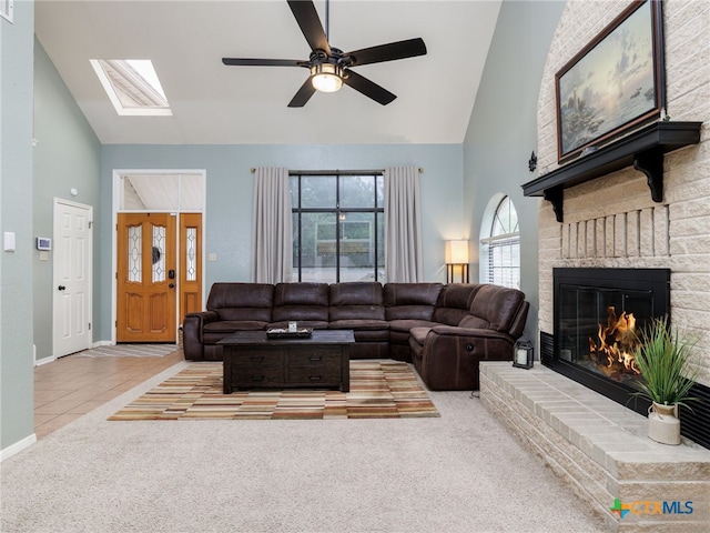 tiled living room featuring carpet floors, a fireplace, high vaulted ceiling, and baseboards