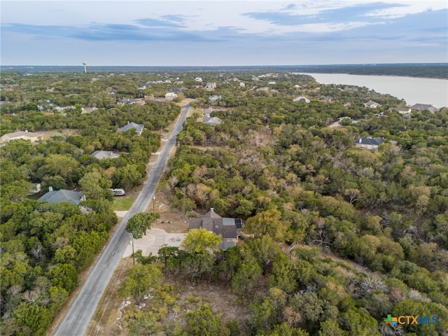 aerial view featuring a water view and a forest view