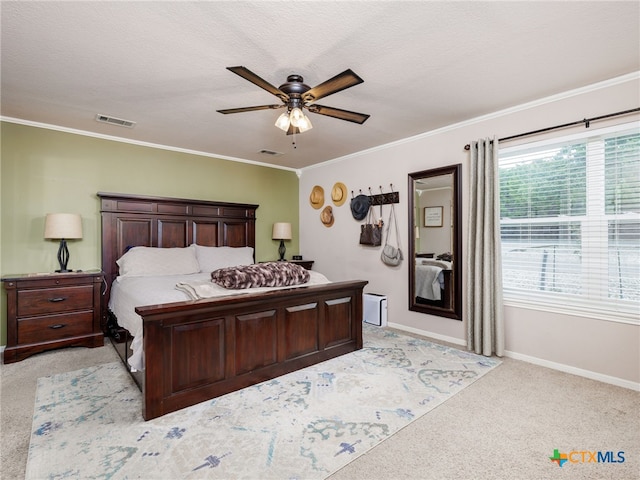 bedroom with visible vents, crown molding, and light carpet