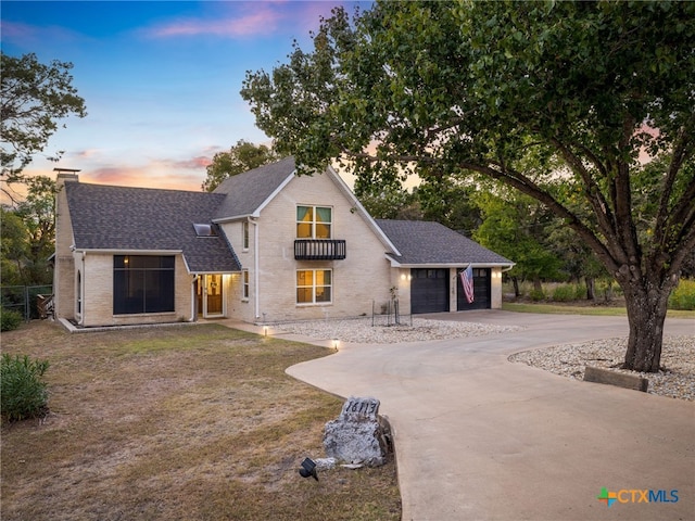 view of front of home with a garage, a chimney, concrete driveway, and roof with shingles