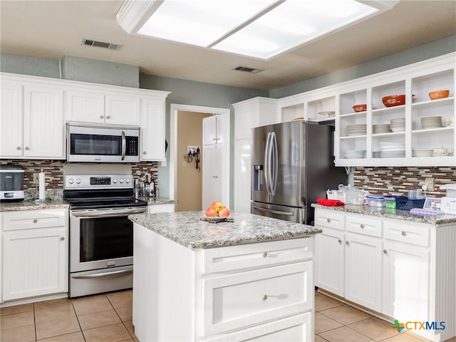 kitchen featuring light tile patterned floors, visible vents, appliances with stainless steel finishes, and open shelves