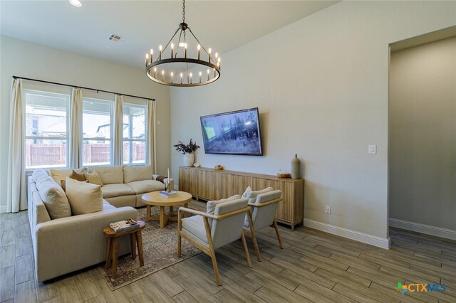 living room with wood-type flooring and a chandelier