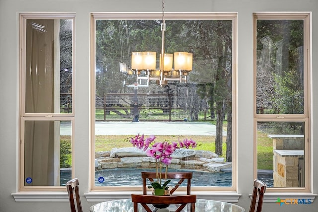 interior space featuring plenty of natural light and an inviting chandelier