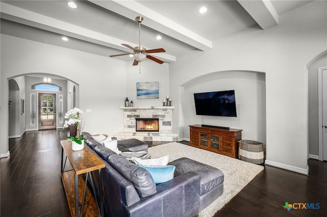 living room featuring beamed ceiling, dark wood-style floors, recessed lighting, a fireplace, and baseboards