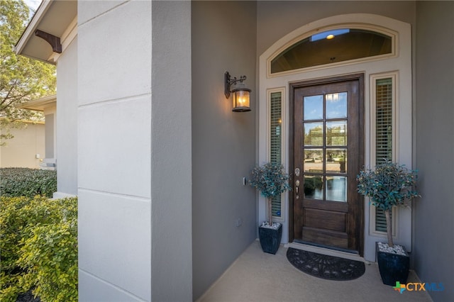 property entrance with stucco siding