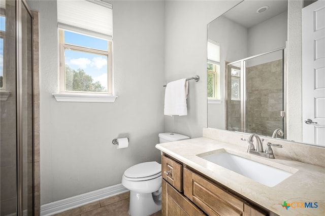 full bathroom with vanity, baseboards, a stall shower, tile patterned floors, and toilet