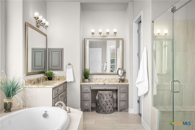 bathroom featuring wood tiled floor, vanity, a stall shower, and a whirlpool tub