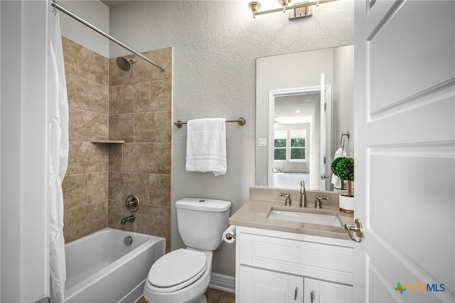 full bathroom featuring vanity, toilet, a textured wall, and shower / bath combo